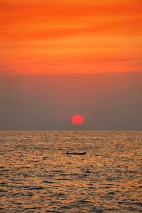 Scenic view of sea against orange sky during sunset