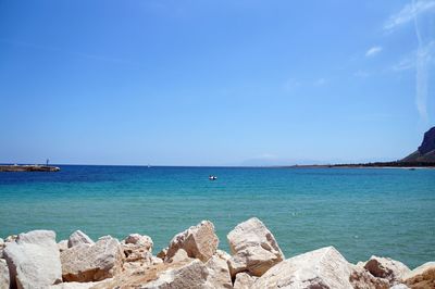 Scenic view of sea against clear blue sky