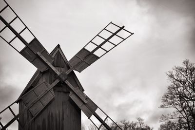 Low angle view of traditional windmill against sky