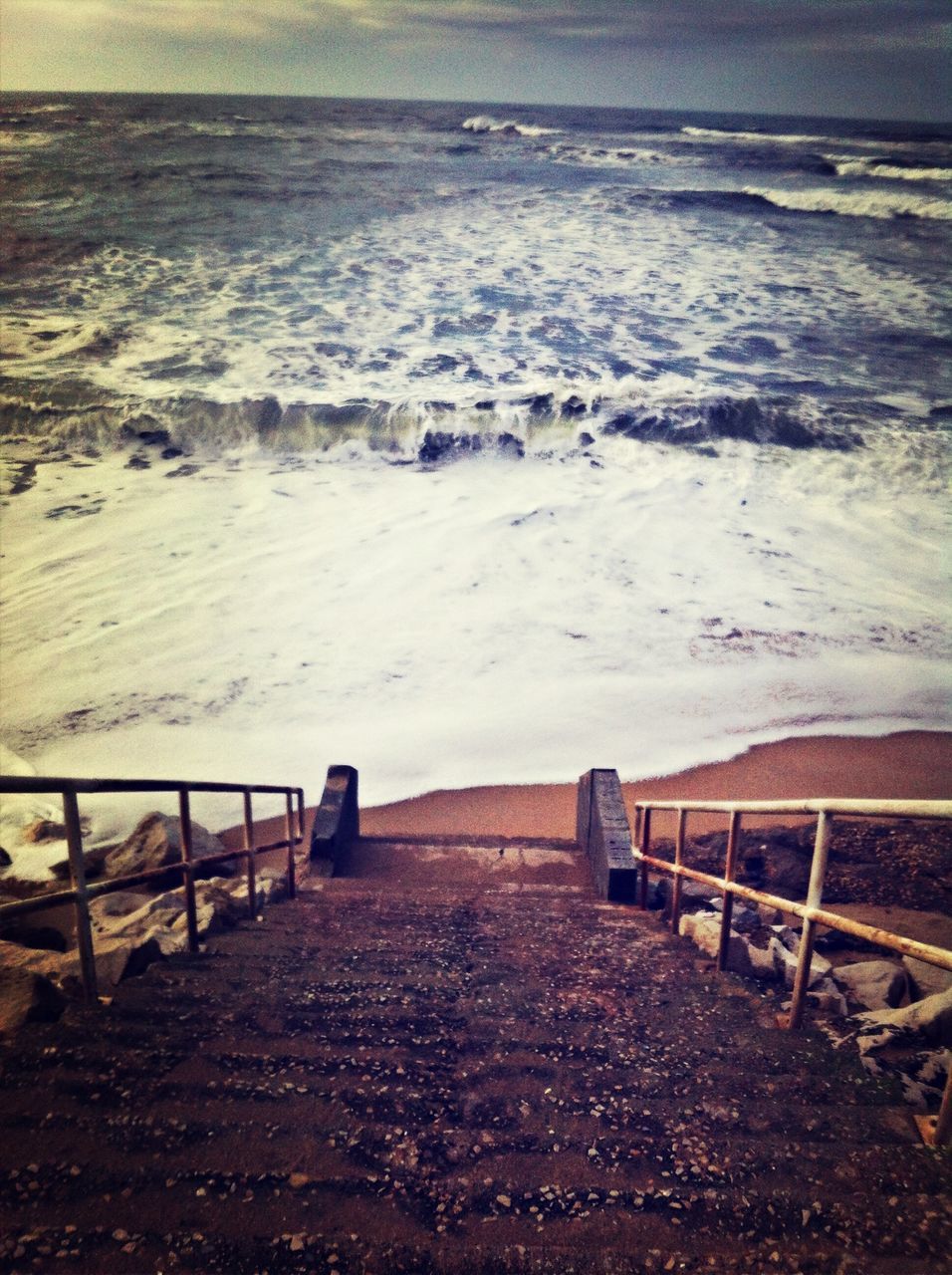 water, sea, beach, shore, tranquility, scenics, nature, horizon over water, tranquil scene, beauty in nature, wave, surf, railing, pier, sand, wood - material, sky, the way forward, idyllic, outdoors