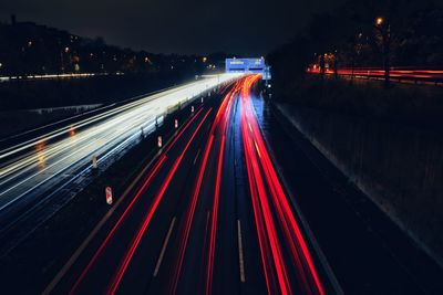 High angle view of light trails on road at night