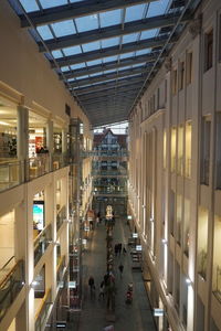 People walking in illuminated building