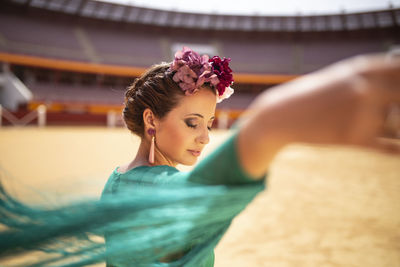 Side view of young woman sitting at home