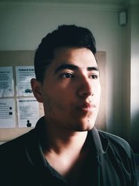 Close-up portrait of young man at home