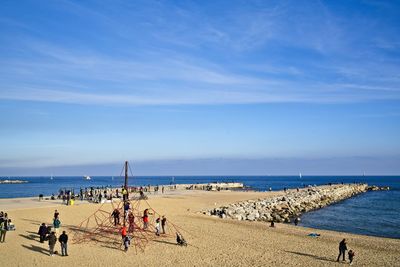 People on beach against sky
