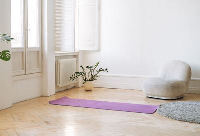 Empty living room with fitness mats on floor