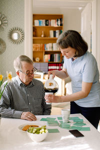 Woman holding food while standing on table