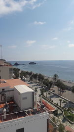 High angle view of buildings by sea against sky