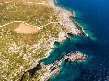 High angle view of rocks on sea shore