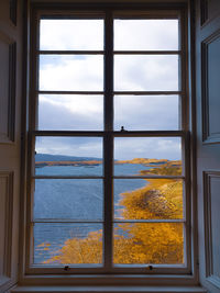 Scenic view of sea seen through glass window