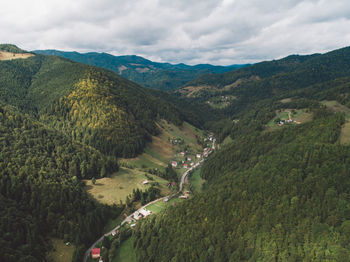 High angle view of green landscape against sky