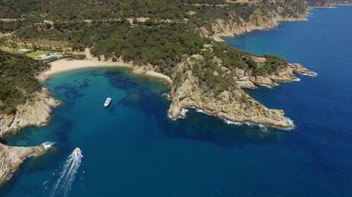 High angle view of sea by mountain