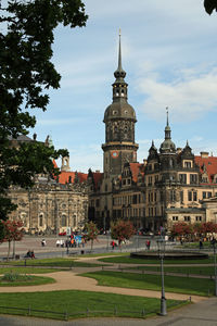 Group of people in front of historical building against sky