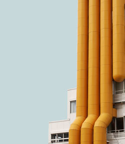 Low angle view of industrial building against clear sky