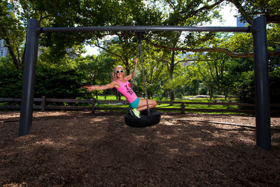 Full length of woman on swing at park