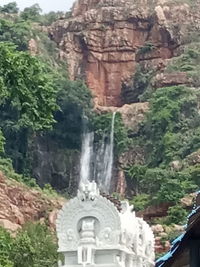 View of waterfall with mountain in background