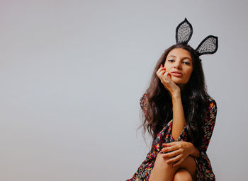 Portrait of a beautiful young woman over white background