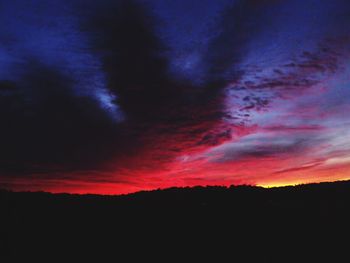 Silhouette of landscape against dramatic sky