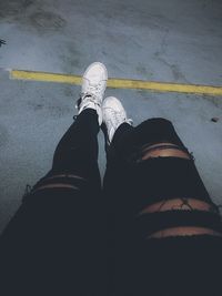 Low section of woman standing on tiled floor