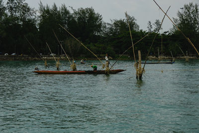 Fishing boat in sea against sky