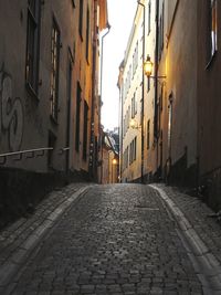 Empty alley amidst buildings in city