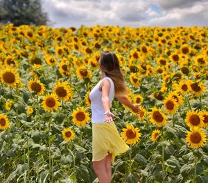 Rear view of woman standing on field