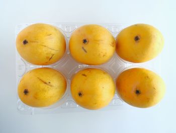 High angle view of orange fruits on white background