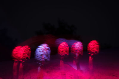 Close-up of illuminated lighting equipment against black background