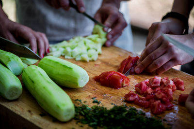 Close-up of man preparing food on cutting board