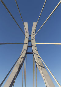 Low angle view of bridge against clear blue sky