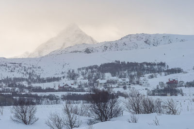 Snow covered landscape against sky