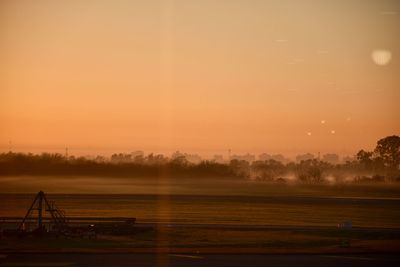 Scenic view of field against sky during sunset