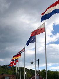 Low angle view of flag flags against sky