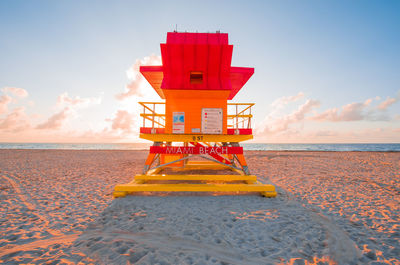 Lifeguard hut on beach against sky