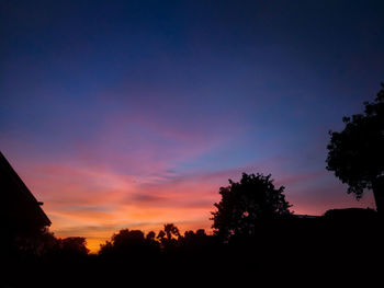 Low angle view of silhouette trees against sky during sunset