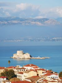 Townscape by sea against sky in city