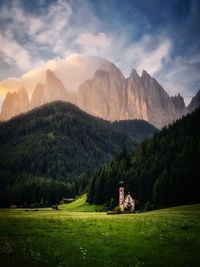 Scenic view of field and mountains against sky