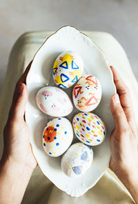 Cropped hand of person holding multi colored candies