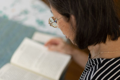 Close-up of woman reading book