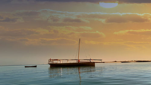Sailboat on sea against sky during sunset