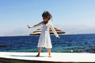 Girl dancing on seashore