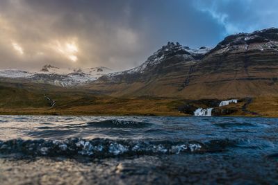 Scenic view of lake and mountains against sky