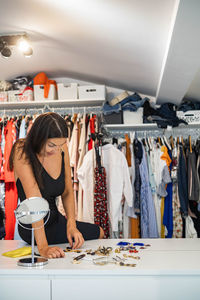 Woman standing on table in store