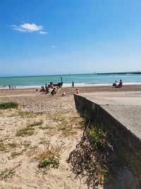 People on beach against sky