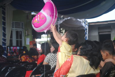 Rear view of people with balloons