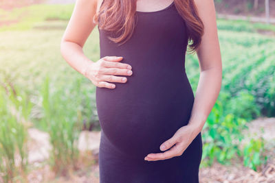 Midsection of woman wearing hat