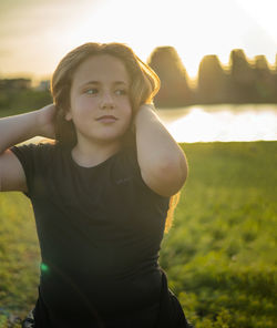 Portrait of woman standing on field