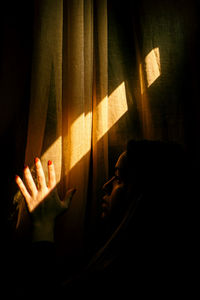 Shadow of people hand on curtain