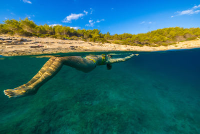 Girl diving in the adriatic sea on hvar island, croatia