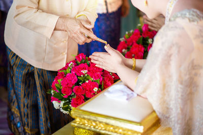 Bride and priest in church during wedding ceremony